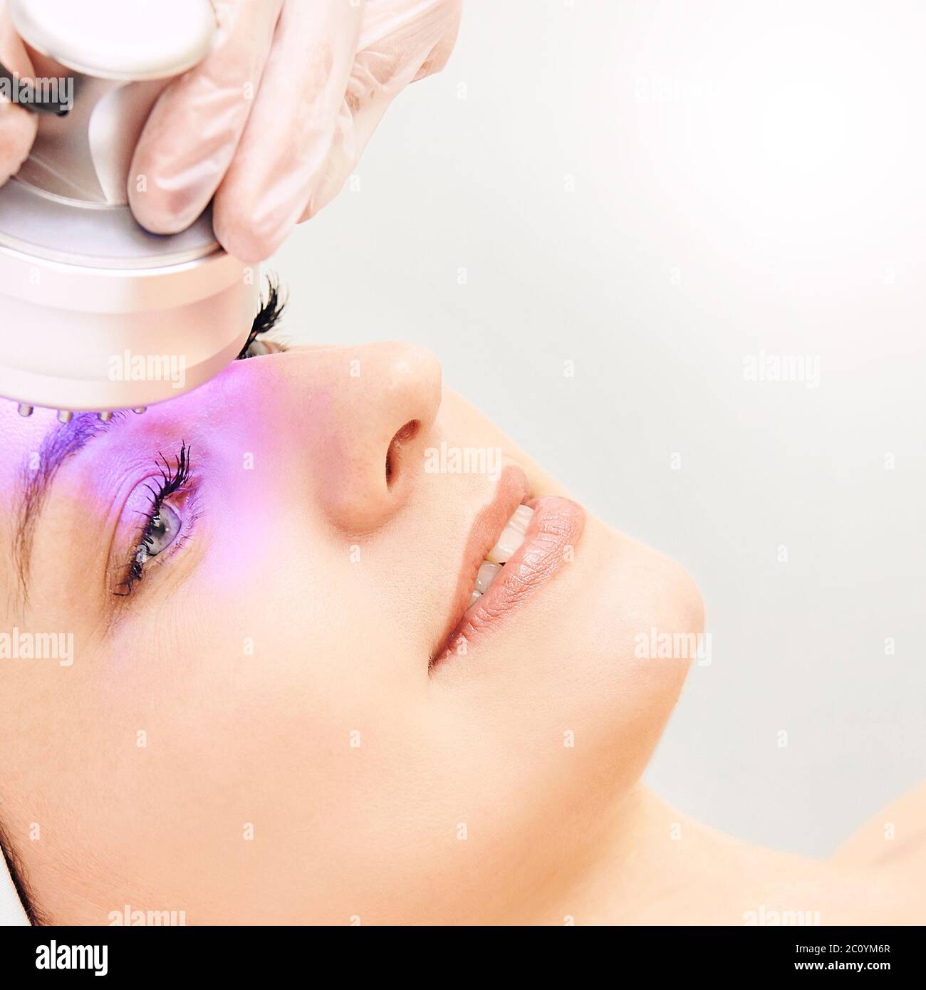 Light infrared therapy. Cosmetology head procedure. Beauty woman face