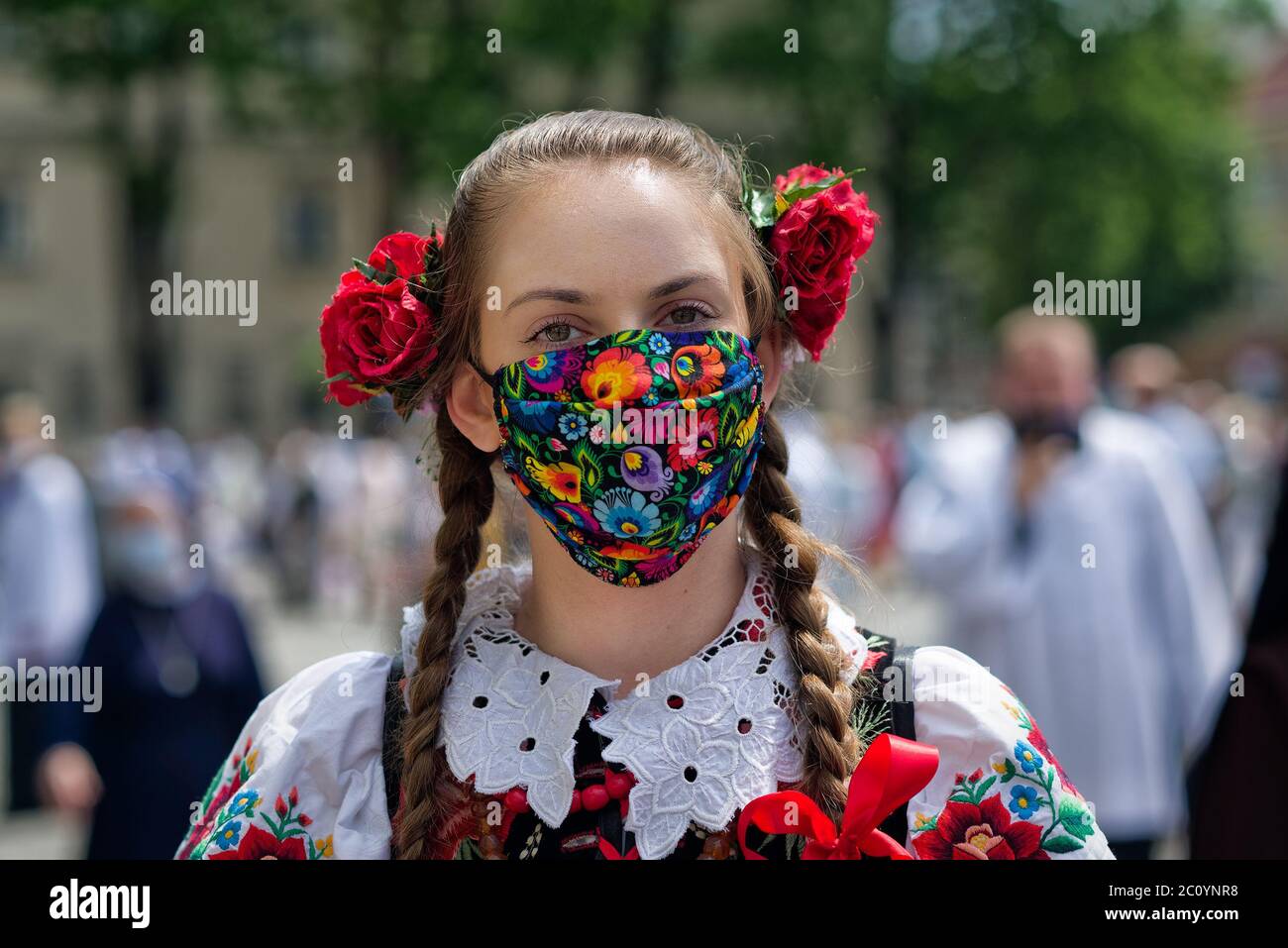 Lowicz, Poland - June 11 2020: An unidentified pretty young polish girl wearing traditional folk Lowicz national costume while joins Corpus Christi pr Stock Photo