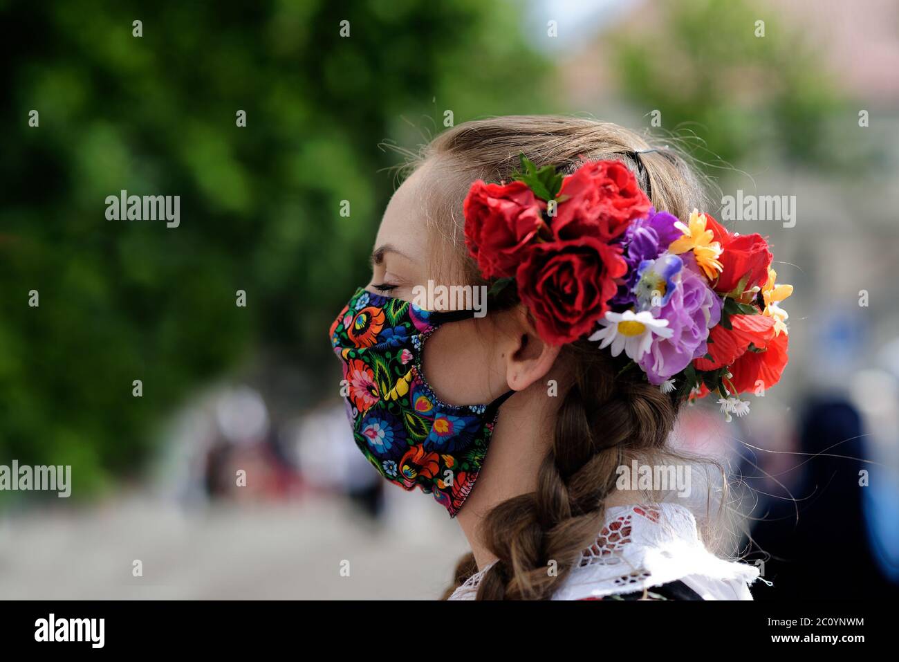 Lowicz, Poland - June 11 2020: An unidentified pretty young polish girl wearing traditional folk Lowicz national costume while joins Corpus Christi pr Stock Photo