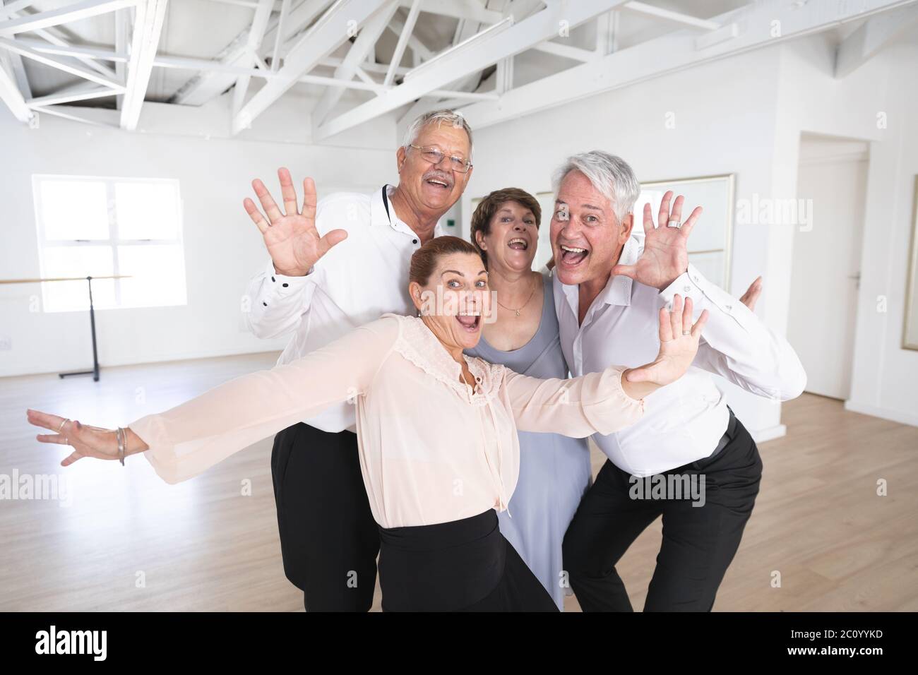 Portrait of happy Caucasian senior couples during ballroom dancing Stock Photo