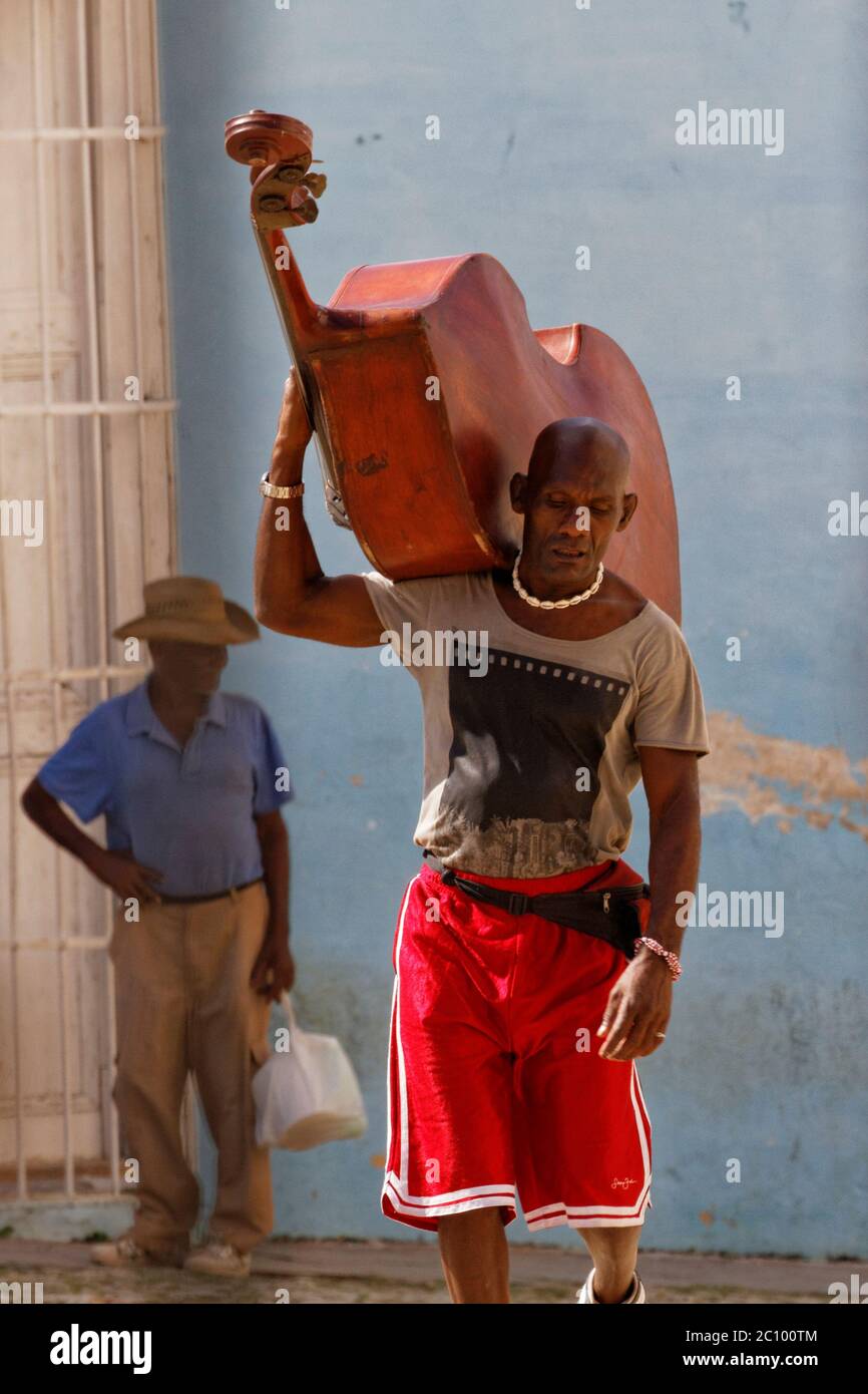 Trinidad, Cuba-Nov 24, 2013: Traditional Cuban musician with his double bass on his shoulder, Trinidad, Cuba Stock Photo