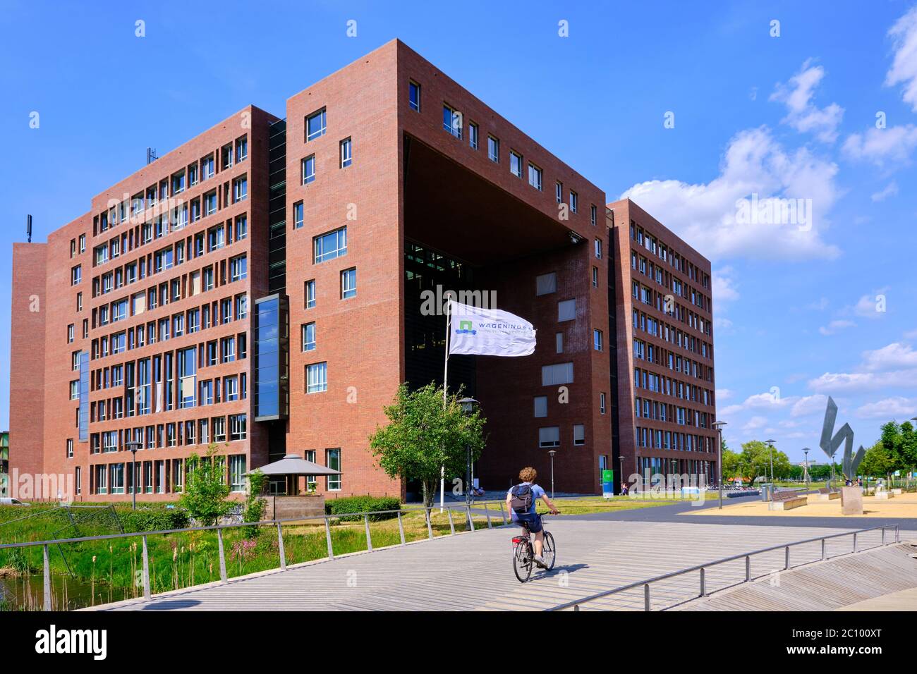 Wageningen, the Netherlands, May 26,2020:Forum at Wageningen University Campus in Sunshine, with flag and cyclist Stock Photo