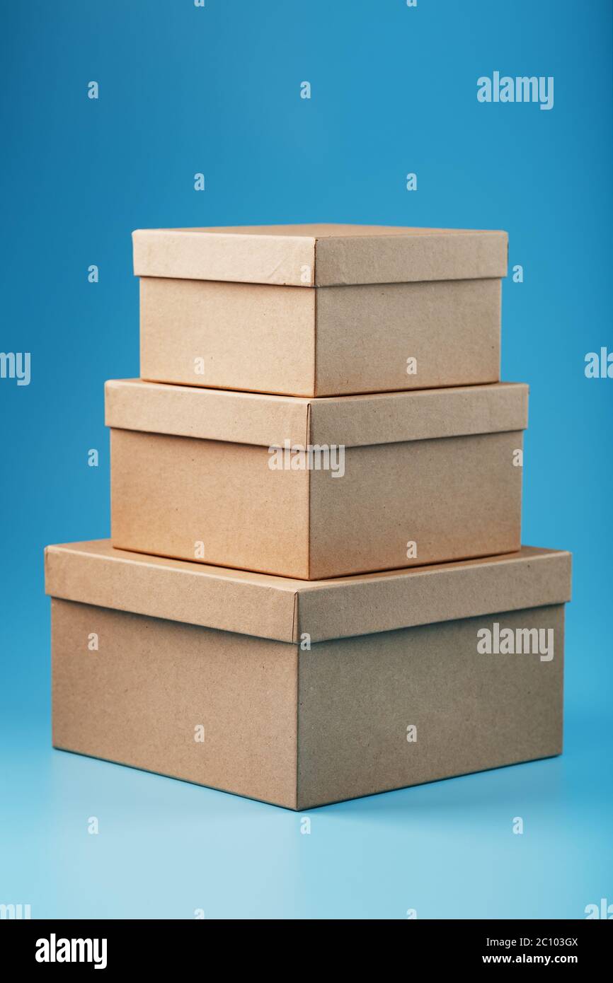 Postal cardboard boxes on a blue background close-up. Stock Photo