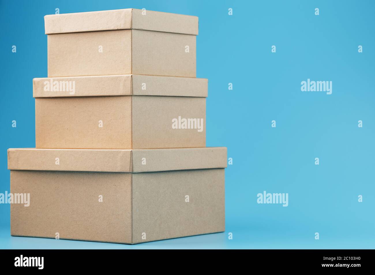 Postal cardboard boxes on a blue background close-up. Stock Photo