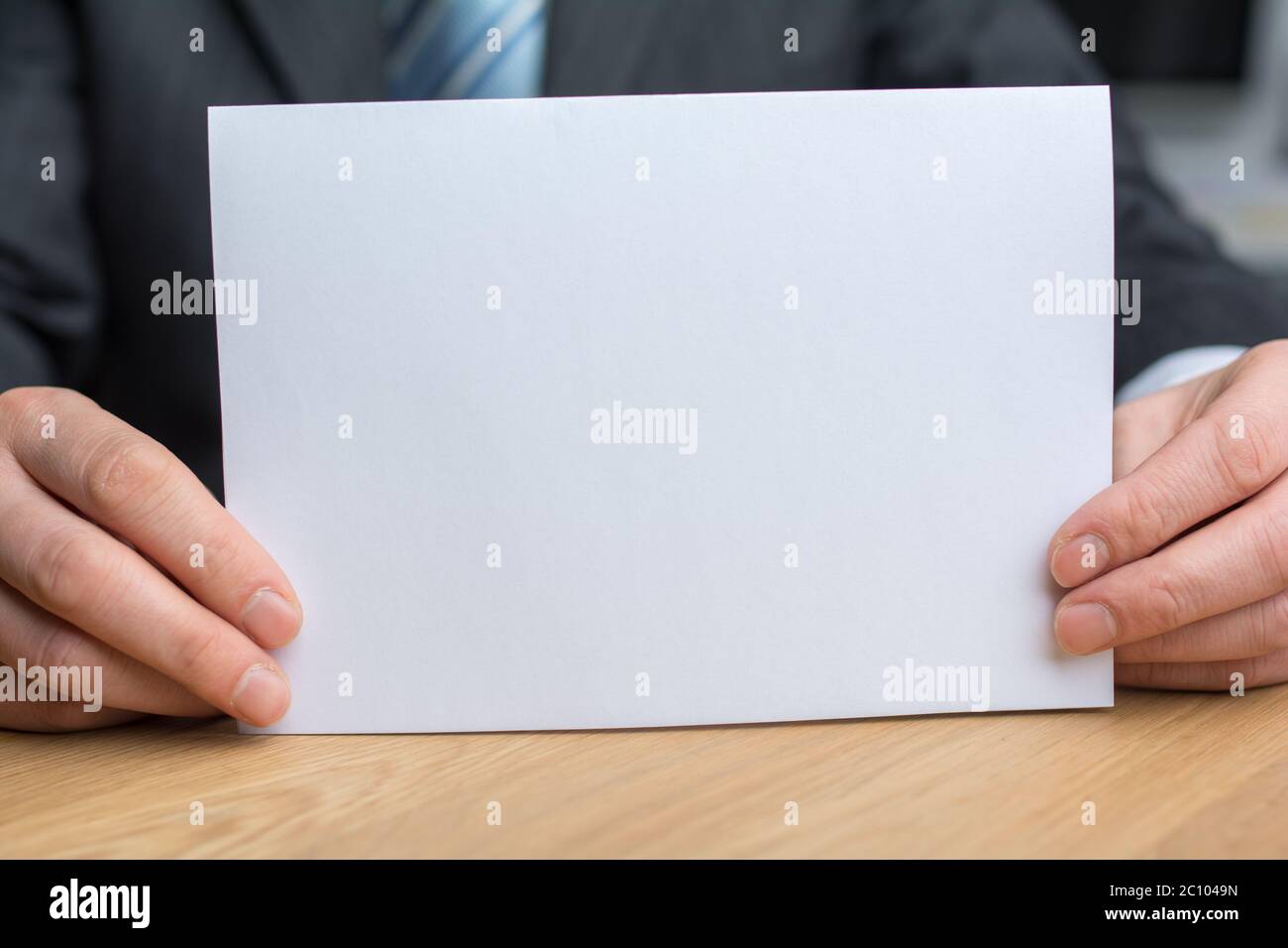 businessman holding white blank paper Stock Photo
