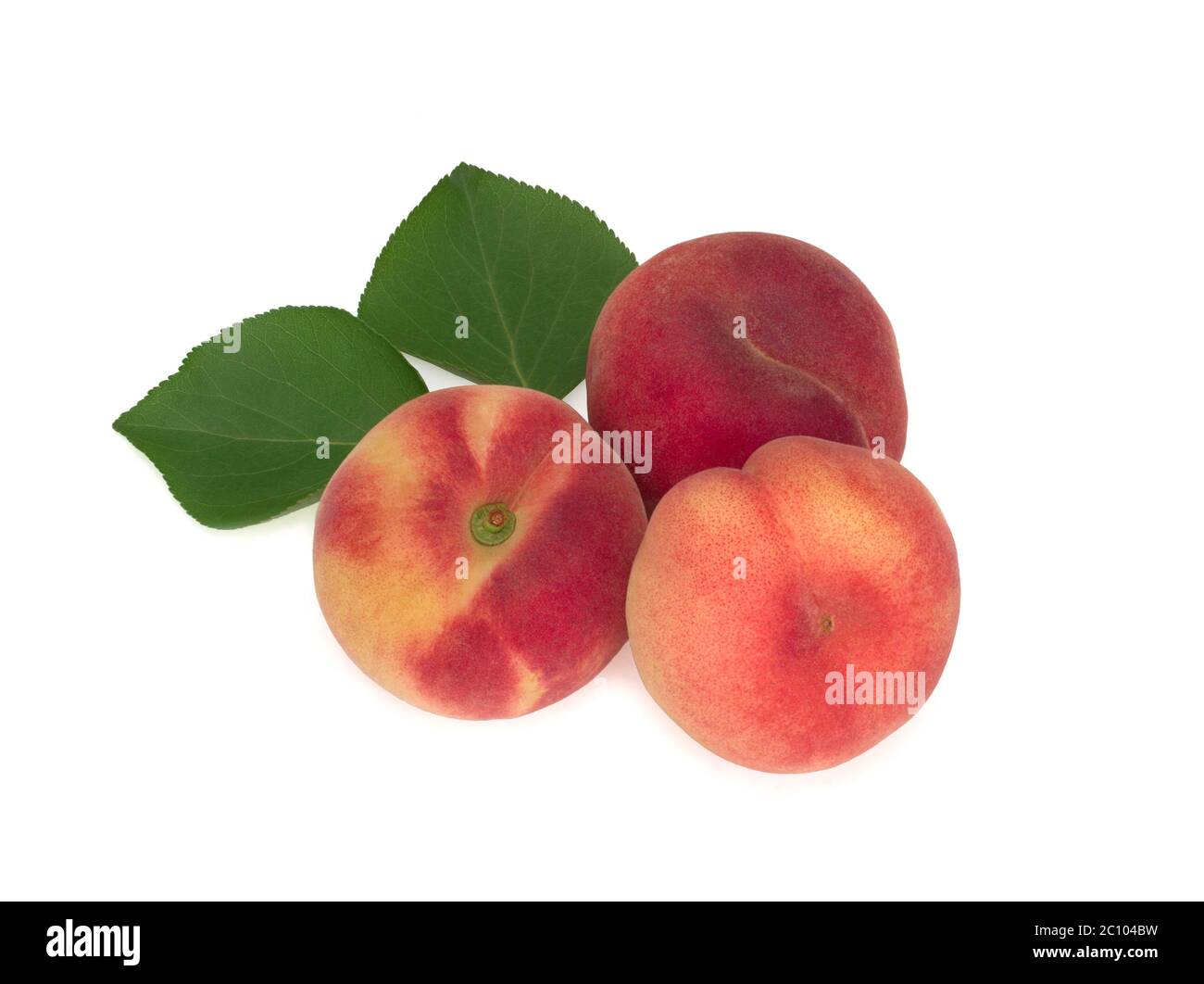 Peaches with leaves isolated on white Stock Photo