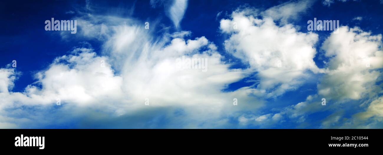 White fluffy clouds in the blue sky. Stock Photo