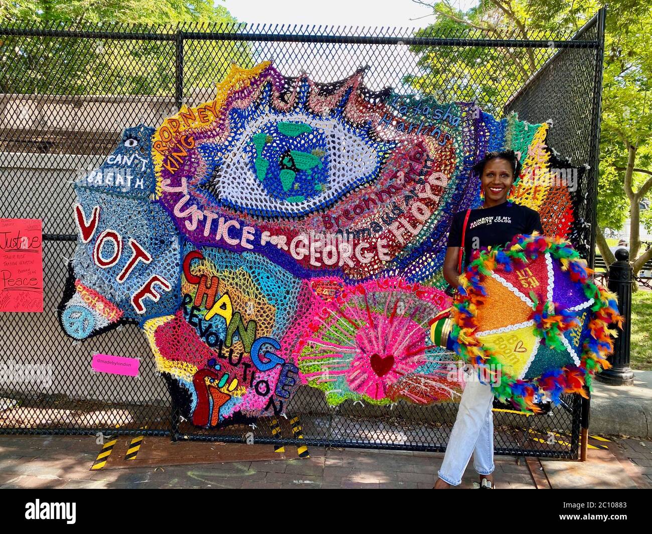 Washington D.C, District of Columbia, USA. 12th June, 2020. New 'Justice for George Floyd' Mural goes up on fence in front of the White House. Hundreds gather all throughout the day to protest police violence and to celebrate African American Culture, liberation and equality at Black Lives Matter Plaza, formerly known as 16th and H Street, the street that leads to the White House. The mood is now more exuberant, hope and festive than in past days, and creative forms of expressions of resistance and support for the community are emerging hour by hour. Credit: Amy Katz/ZUMA Wire/Alamy Live News Stock Photo