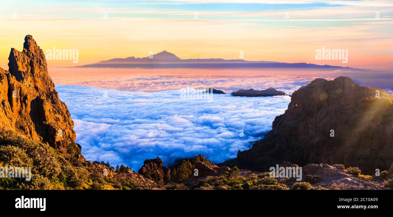 Grand Canary island. Mirador Roque Nublo . Breathtaking  mountains over sunset and view of Tenerife . Stock Photo