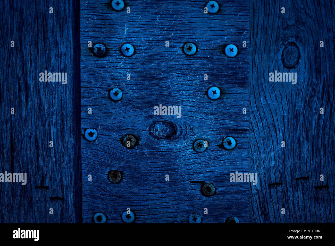 The texture of dark blue wood with old screws. Texture of old dried plywood.  Classic blue background for design Stock Photo - Alamy