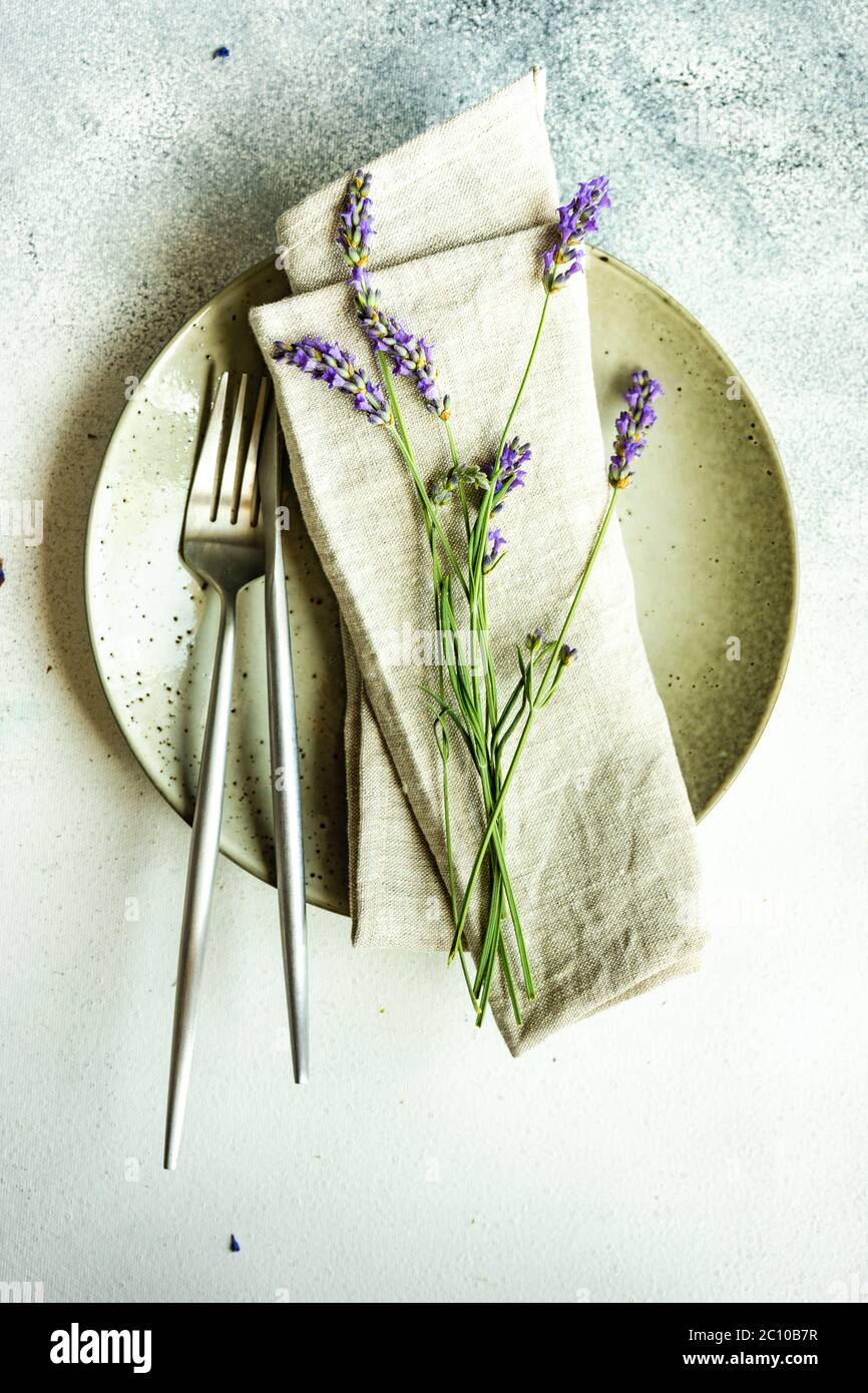 Summer Time Table Set With Minimalistic Stoneware And Cutlery Served On summer-time-table-set-with-minimalistic-stoneware-and-cutlery-served-on