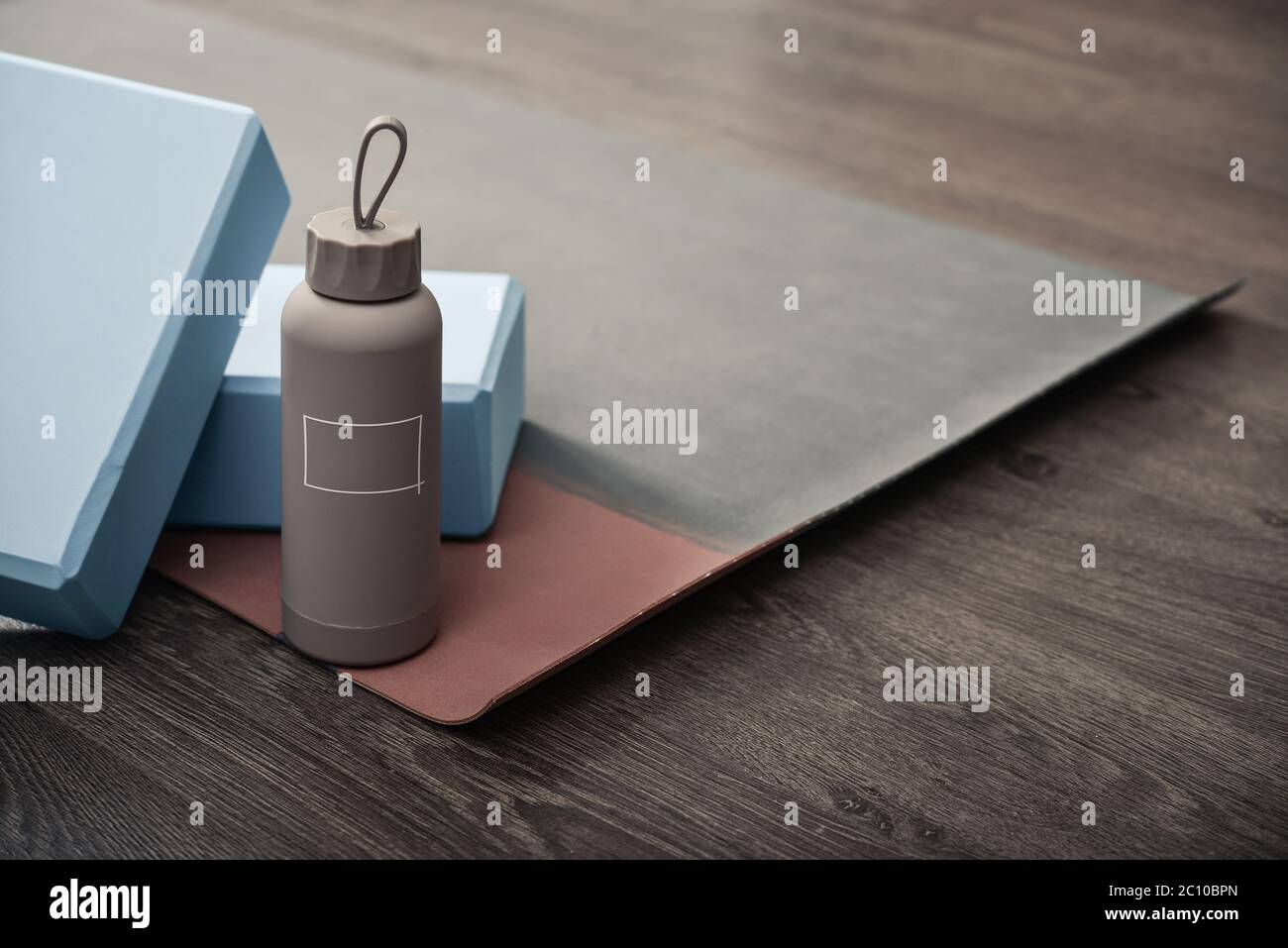 Yoga mat, bottle with water and yoga bricks - accessories for home yoga practice Stock Photo