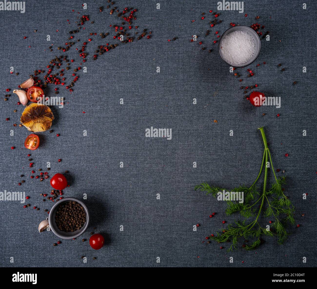 Selection of spices herbs and greens. Ingredients for cooking. Food background on black slate table. Stock Photo