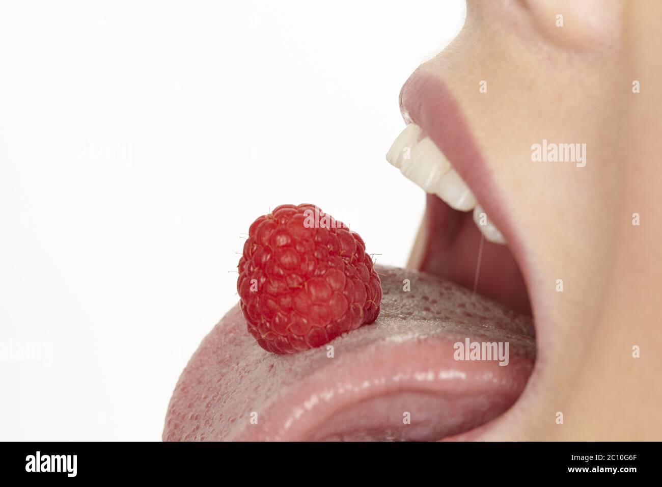 Raspberry on the tongue Stock Photo Alamy