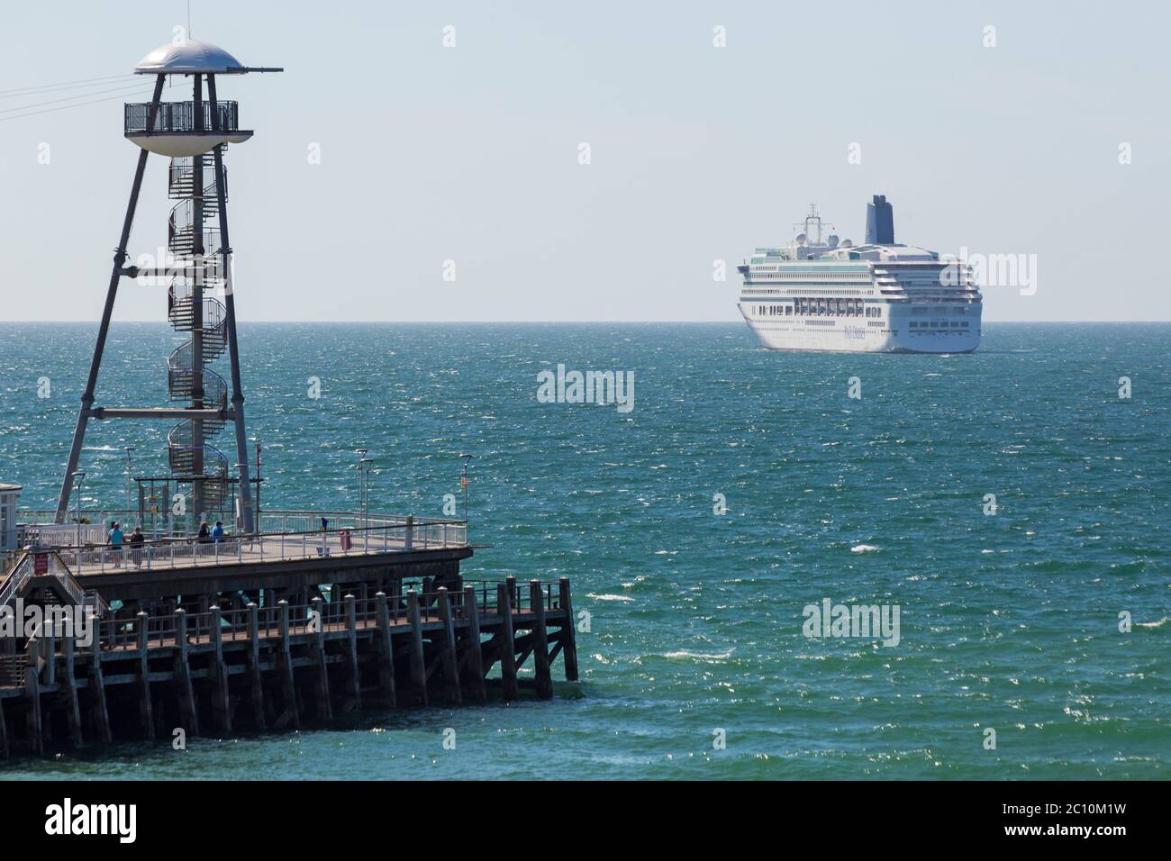 Bournemouth, Dorset UK. 13th June 2020. P&O cruise ship Arcadia joins Aurora moored at Poole Bay, Bournemouth as not enough room at Southampton; they are not cruising due to Coronavirus pandemic closing down the cruising industry forcing the companies to lay up their ships. Viewed from the beach. Credit: Carolyn Jenkins/Alamy Live News Stock Photo