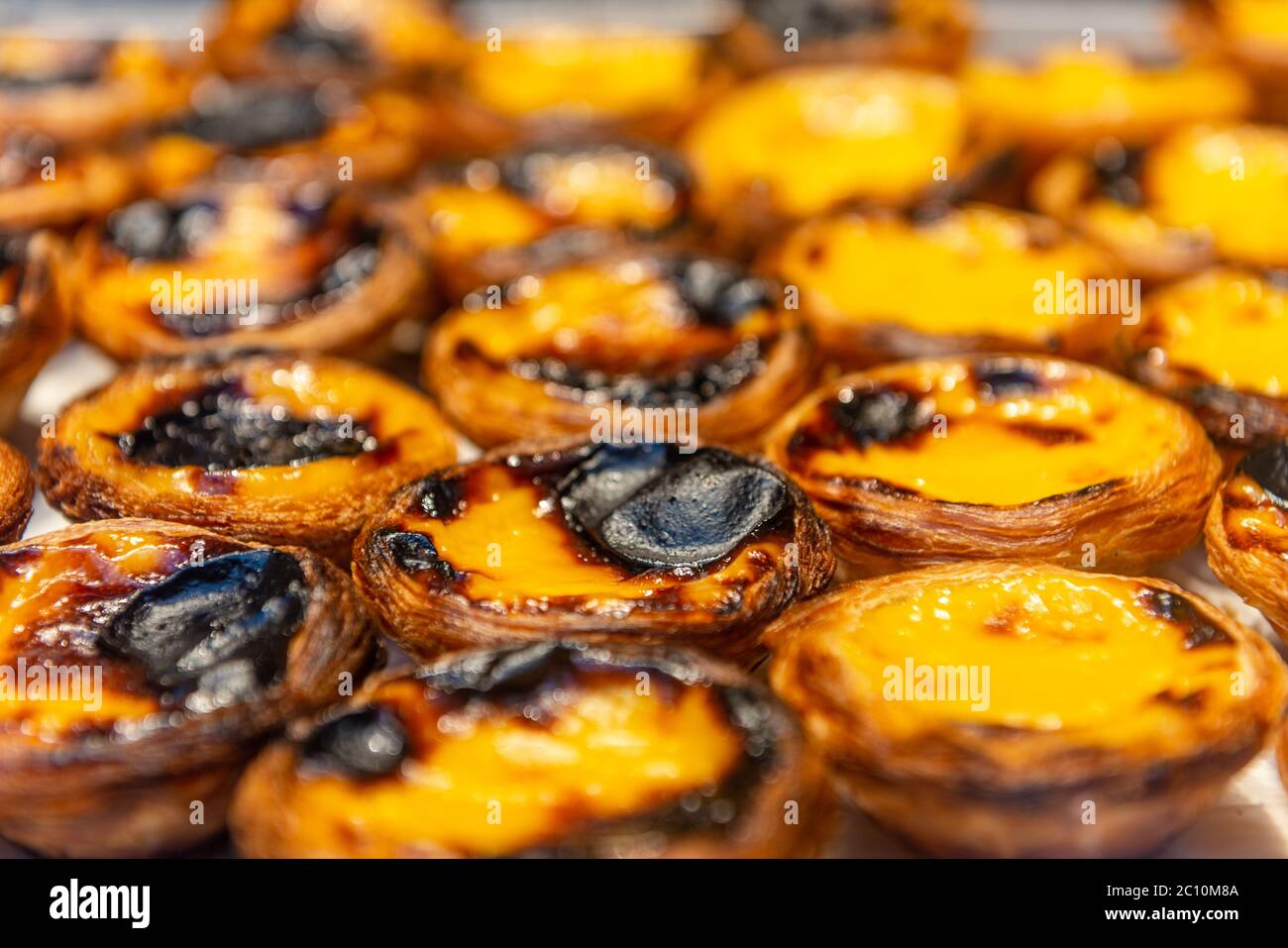Fresh pasteis de nata (typical Portuguese egg tarts) just backed in a local bakery in Lisbon. Stock Photo
