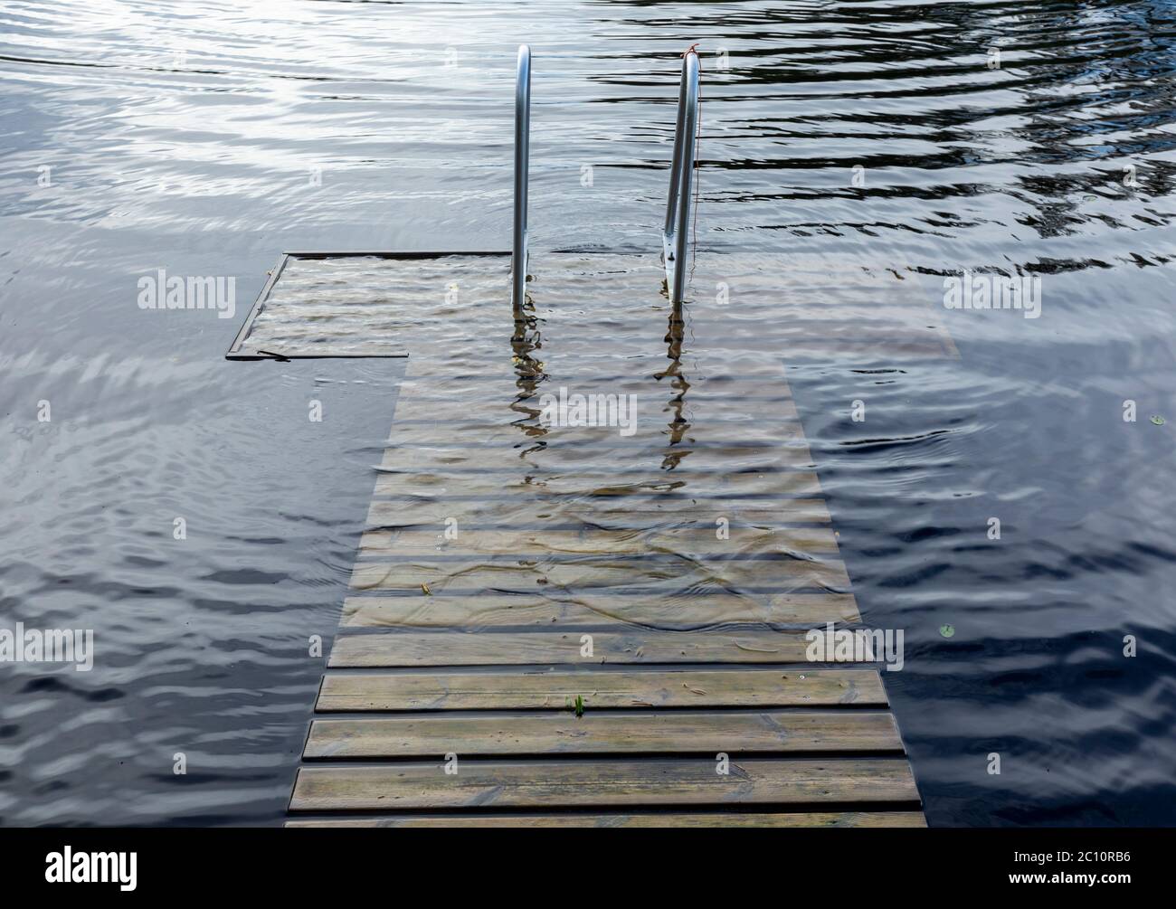 Partially submerged wooden jetty , Finland Stock Photo