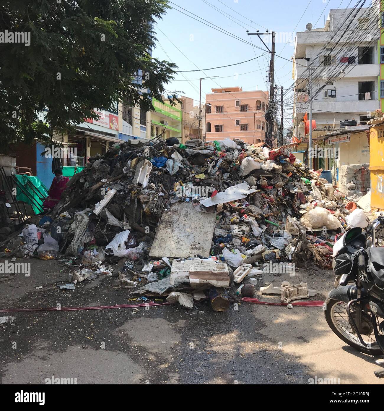 A heap of trash in the middle of a street in India. Trash was removed from desilting nearby