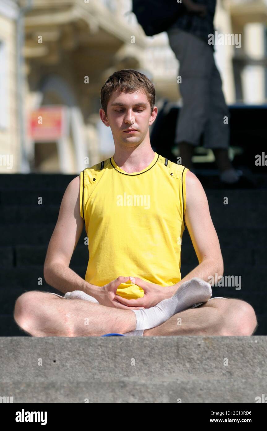 Follower of religious movement Falun dafa doing breathing gymnastics Chi Kung in the street. June 1, 2012. Kiev, Ukraine Stock Photo