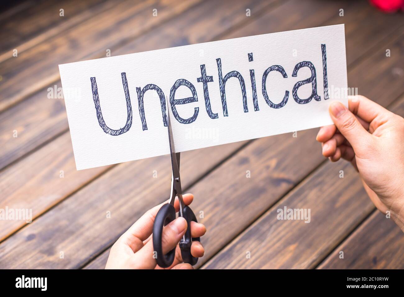 unethical to ethical by scissors Stock Photo