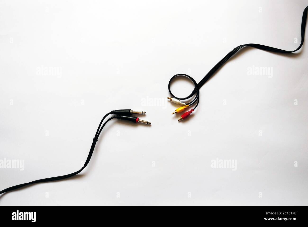 Photo on a white isolated background showing two cables for sound recording. Cord Jack 6.3 mm and RCA jack. You can use this photo as a background for projects related to audio recording, audio connection or a store with cords and cables. High quality photo Stock Photo