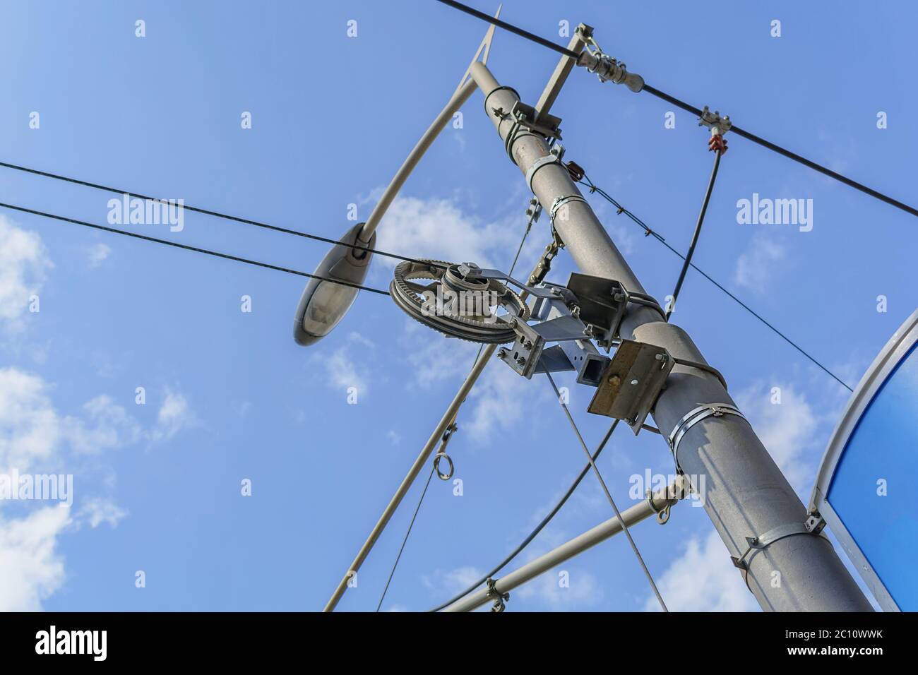 Electricity pole and street light complicated wiring on the lamppost with sky background Stock Photo