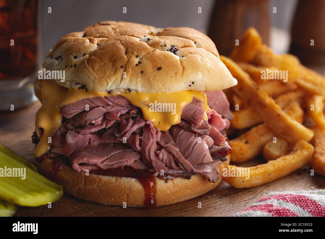 Roast beef sandwich with cheddar cheese and barbecue sauce on an onion