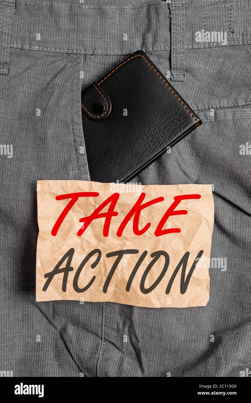 Word writing text Take Action. Business photo showcasing positive act of making a decision to resolve the problem Small little wallet inside man trous Stock Photo