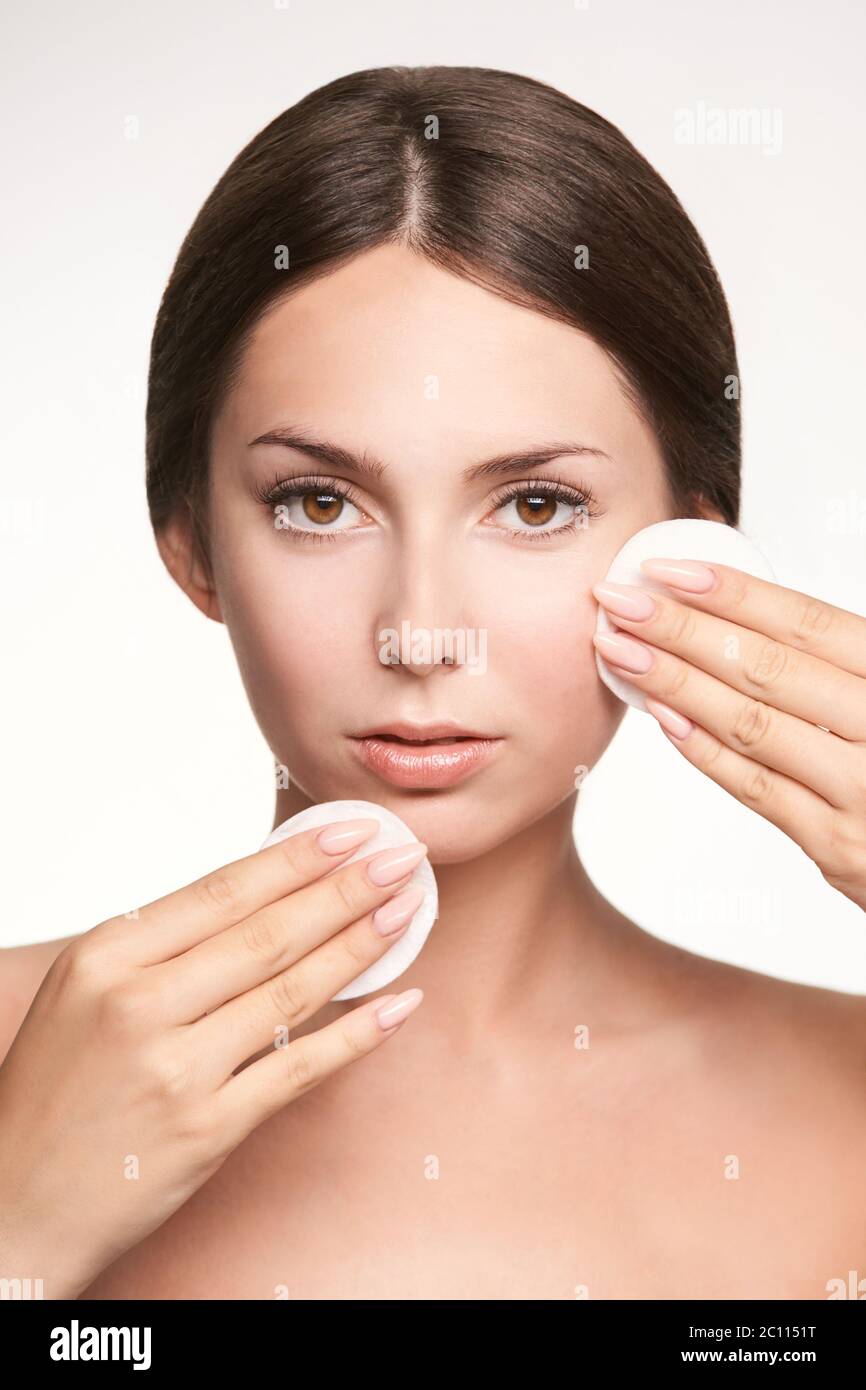 Home face care. Girl remove makeup. Woman hand with pad. Skin clean