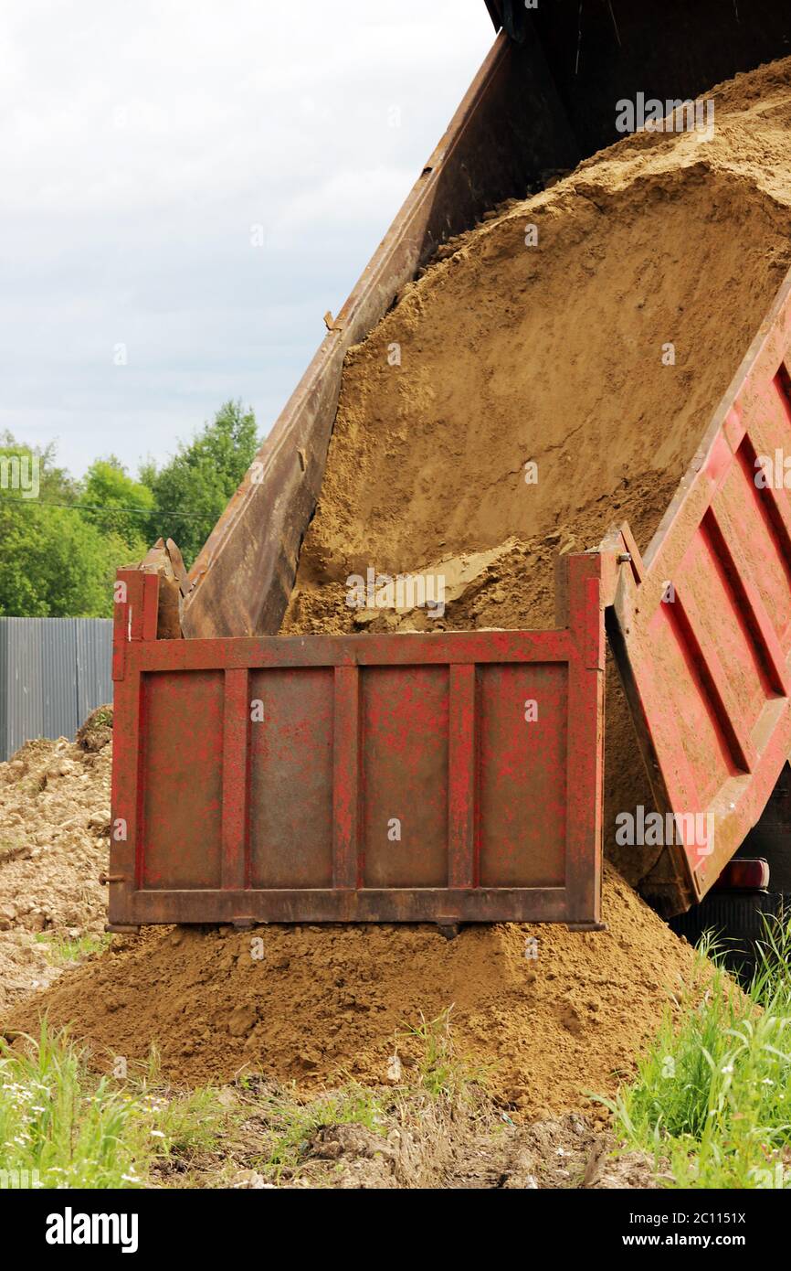 truck unloads sand for backfilling trenches with the pipeline after the