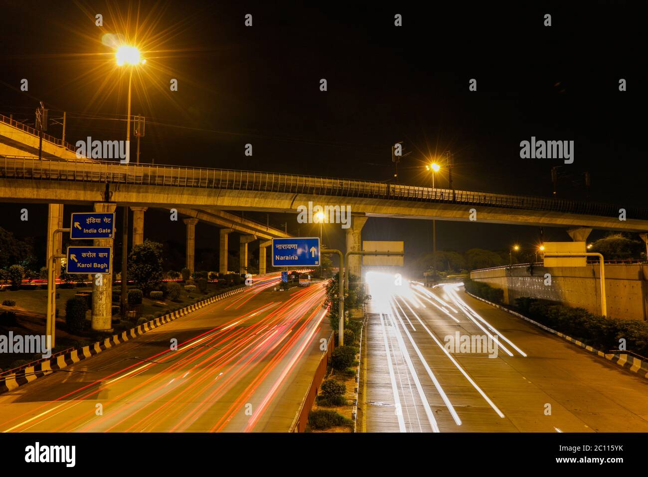 Long exposure image of Delhi Metro passing over the main ring road in New Delhi, India Stock Photo