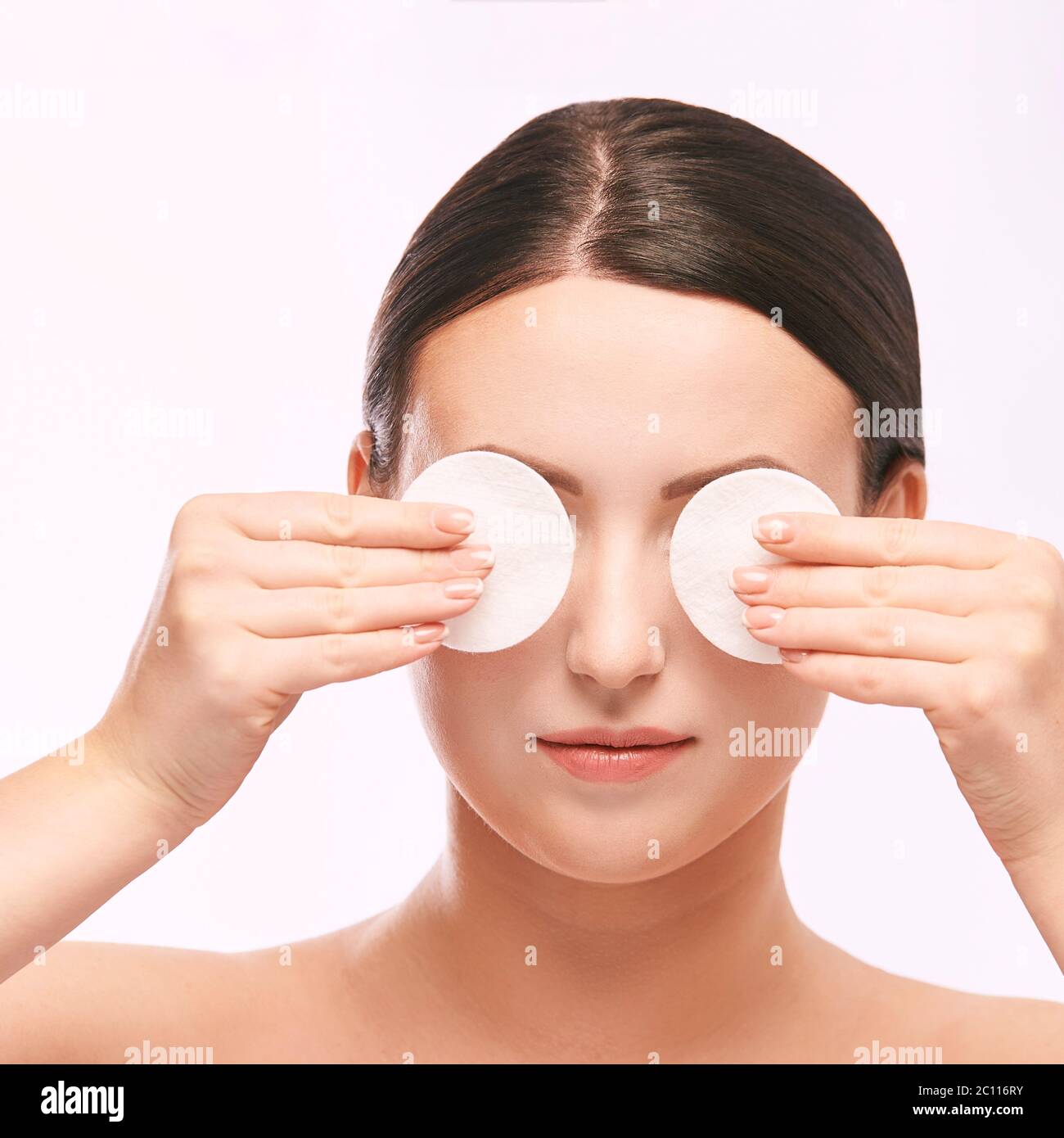 Home face care. Girl remove makeup. Woman hand with pad. Skin clean