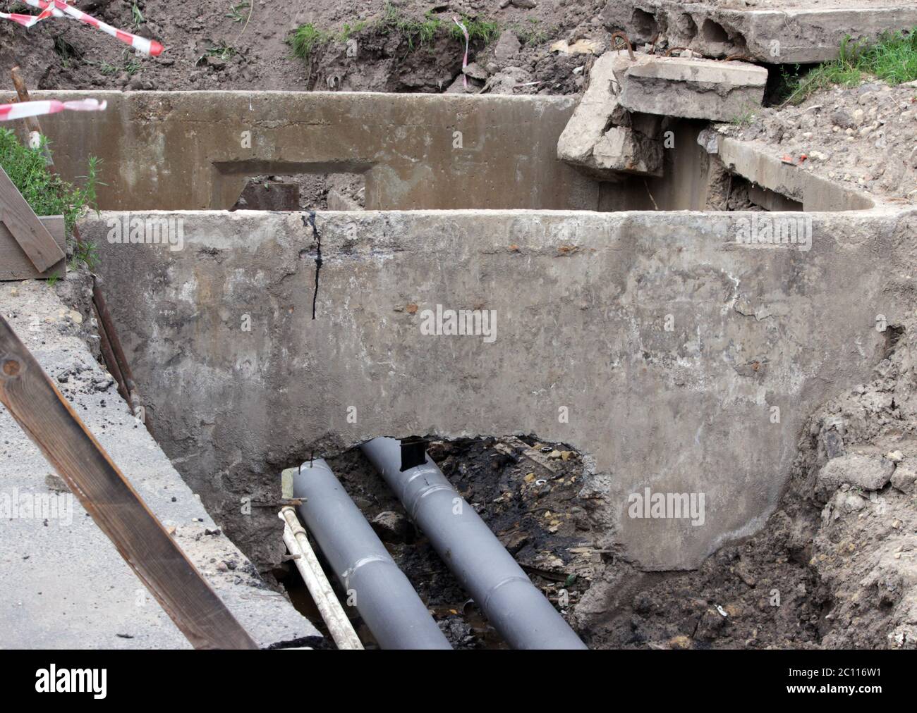 water pipes, insulated roofing sheets during repair in a ditch filled