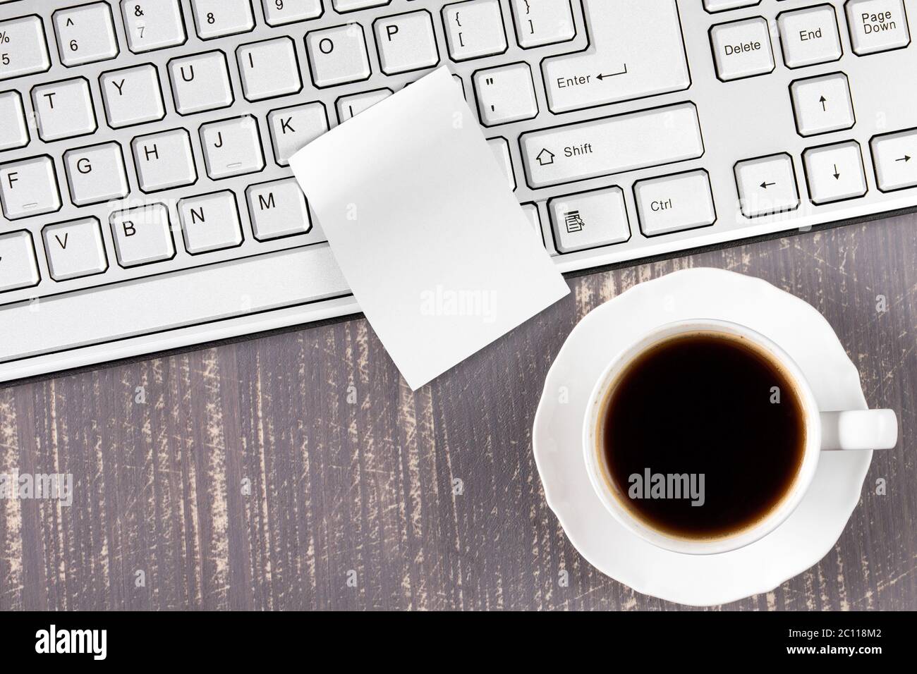 Desk with keyboard and black coffe Stock Photo - Alamy