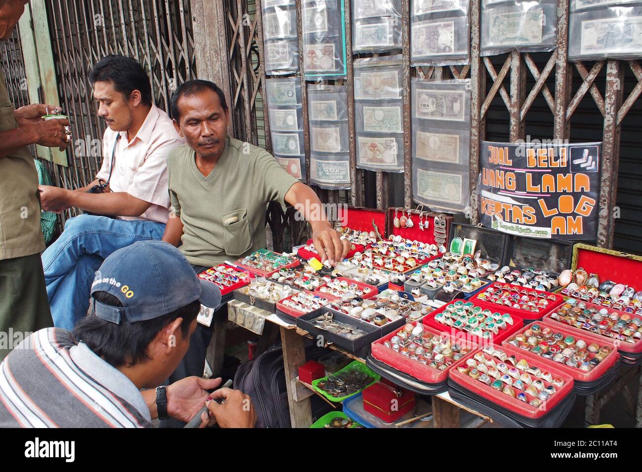Bogor, West Java, Indonesia - December 28, 2013  : Antique traders selling on the sidewalk, peddling rings, agate and ancient money Stock Photo