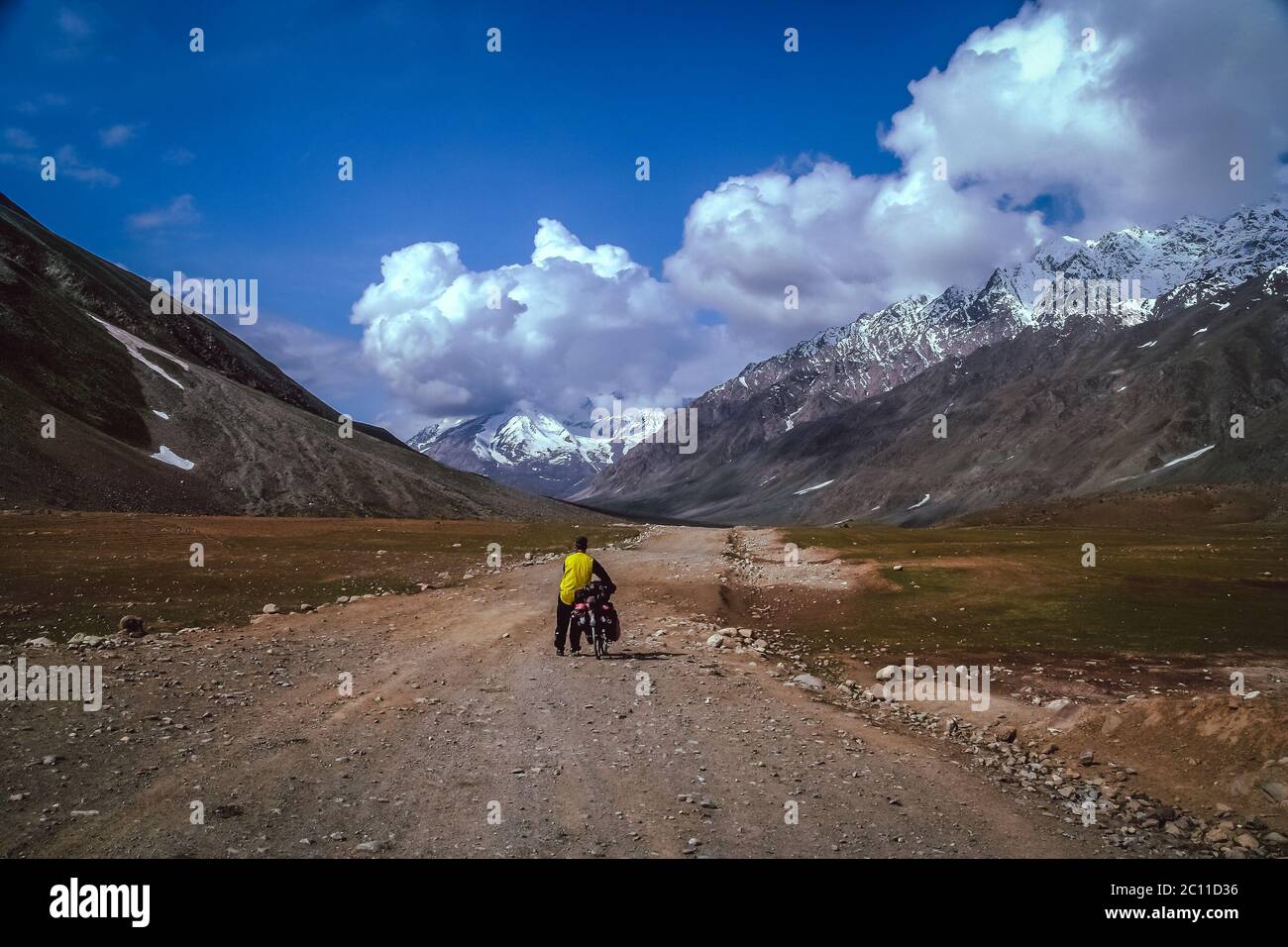 Pushing bike to the top Stock Photo