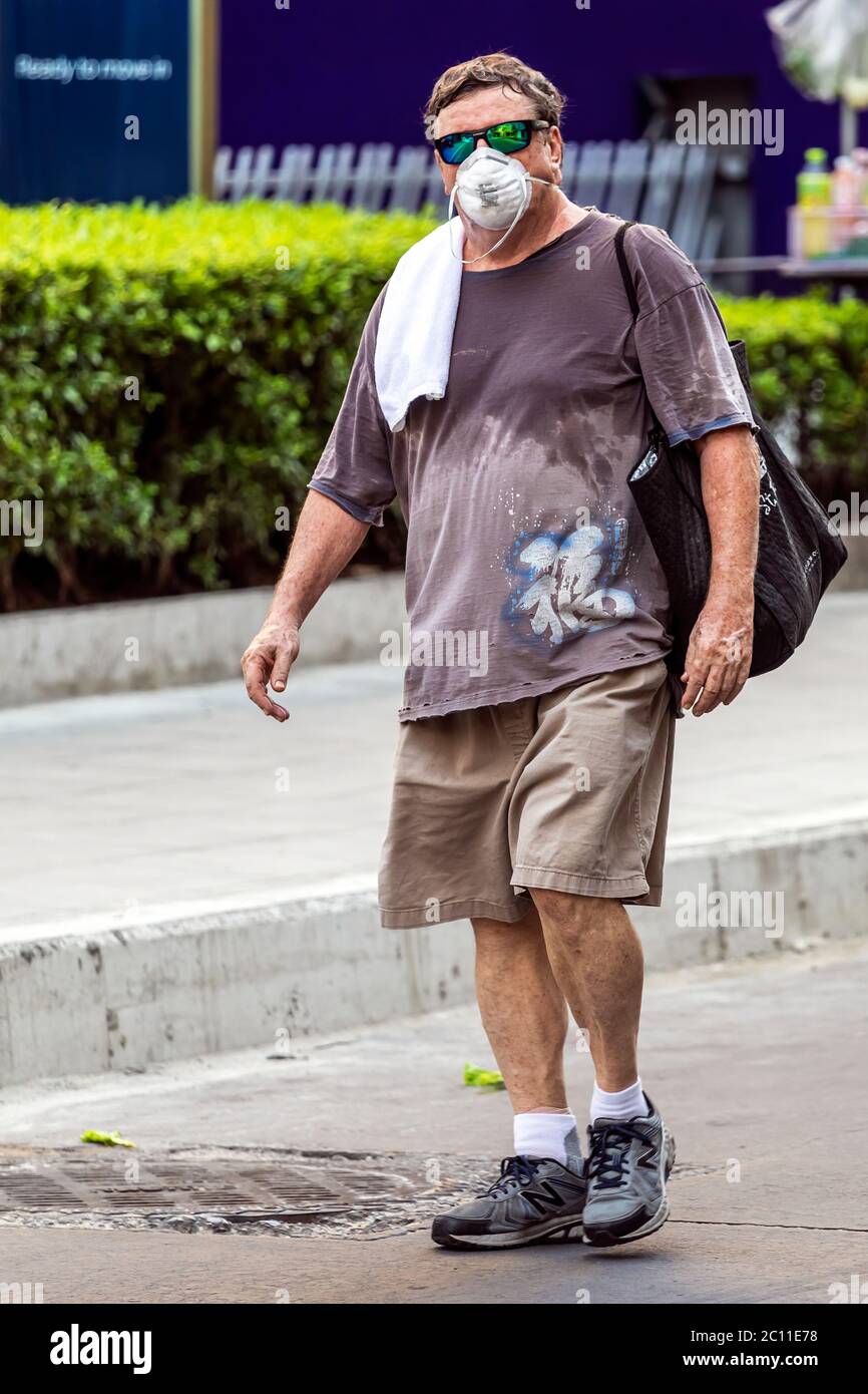 Tourist with face mask walking in the street during Covid pandemic, Bangkok, Thailand Stock Photo