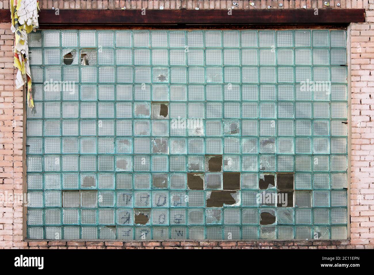 Texture of blue glass bricks with broken elements. Stock Photo