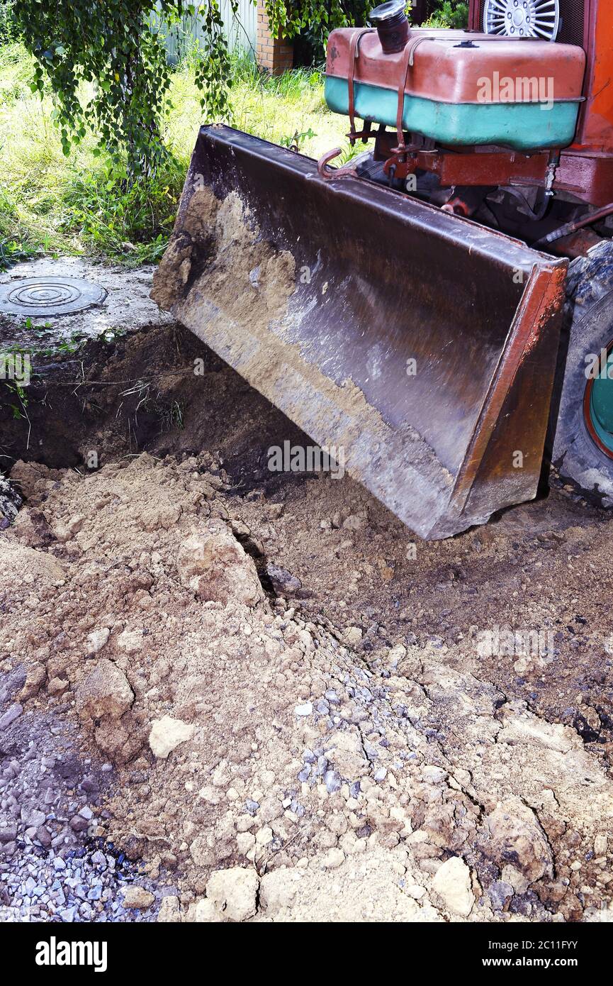 Excavator bucket digging a trench in the dirt ground Excavator bucket