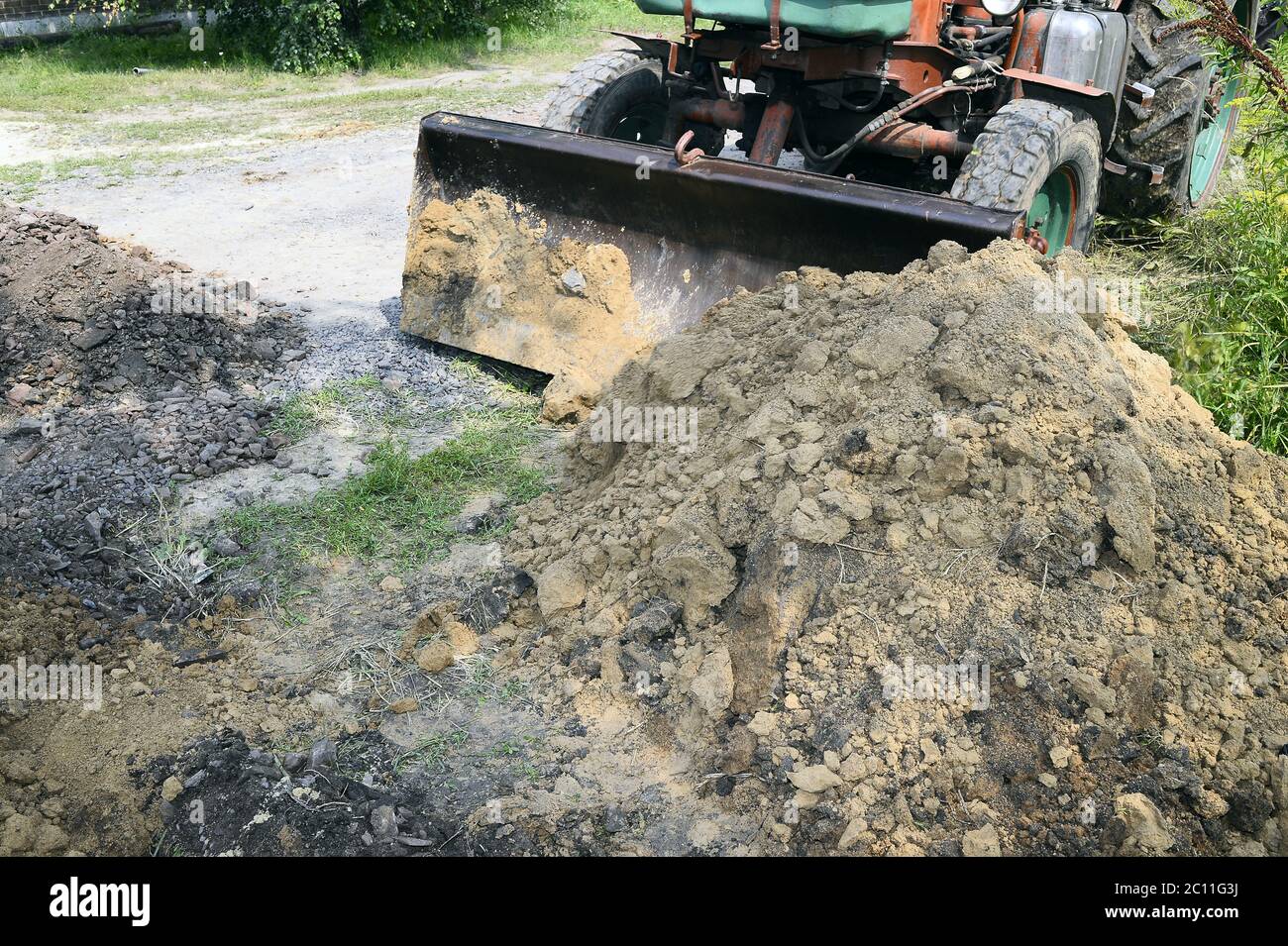 Excavator bucket digging a trench in the dirt ground Excavator bucket