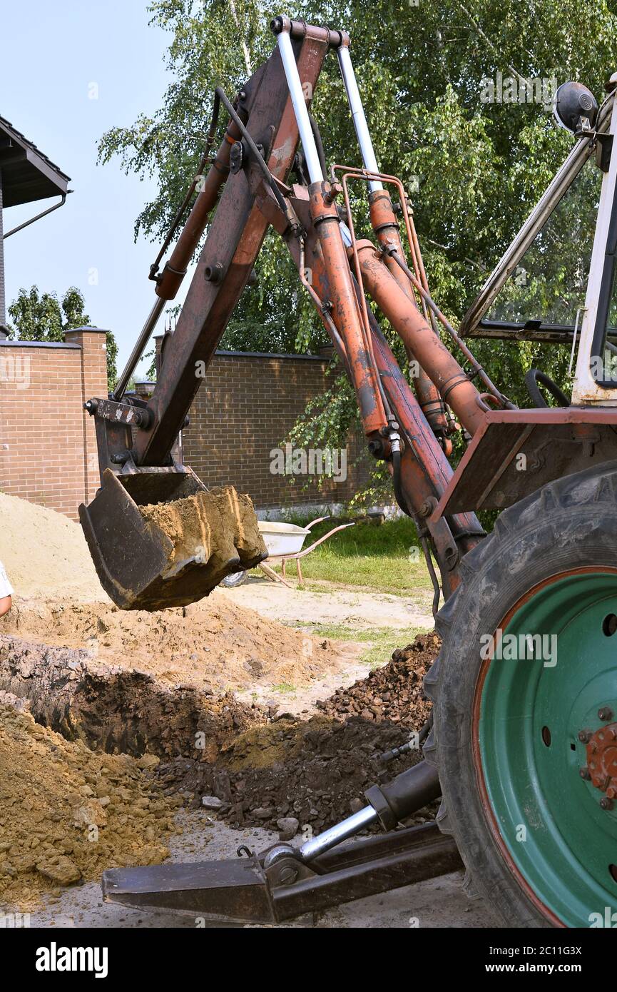Excavator bucket digging a trench in the dirt ground Excavator bucket