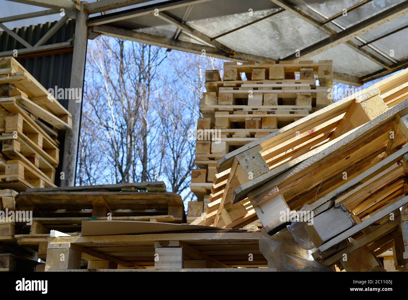 Waste wood from pallets stacked in the storage room Stock Photo