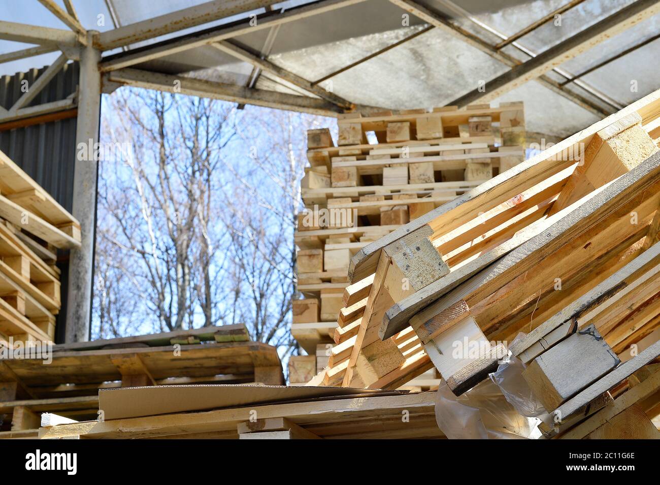 Waste wood from pallets stacked in the storage room Stock Photo