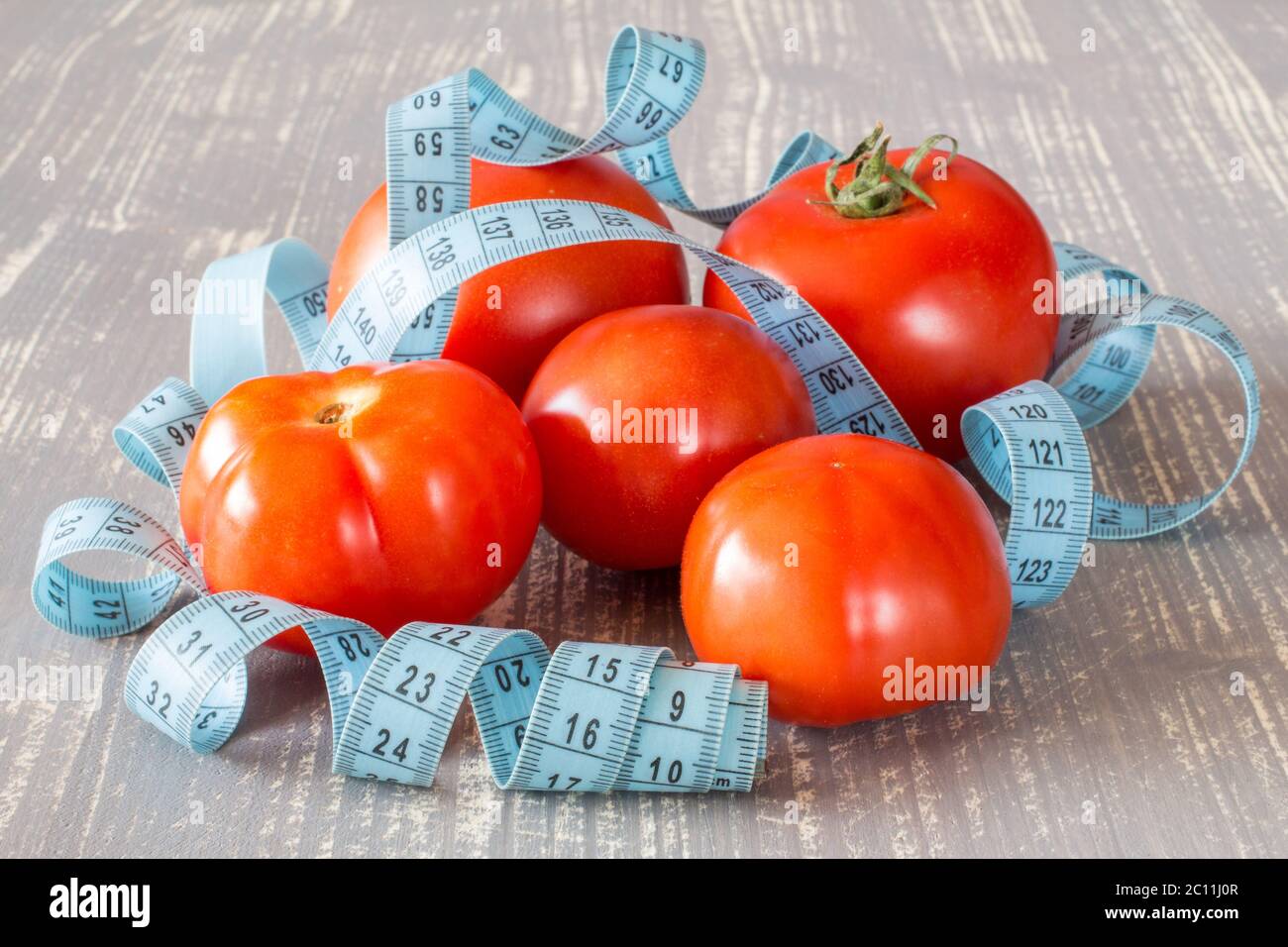 Tomato fruits and tape measure Stock Photo Alamy