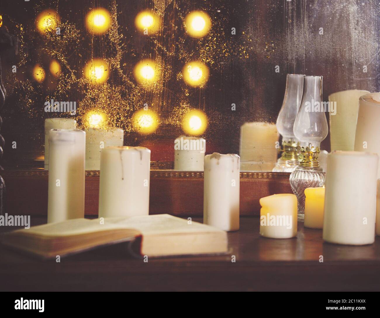 Many burning candles on a mirrored background Stock Photo - Alamy