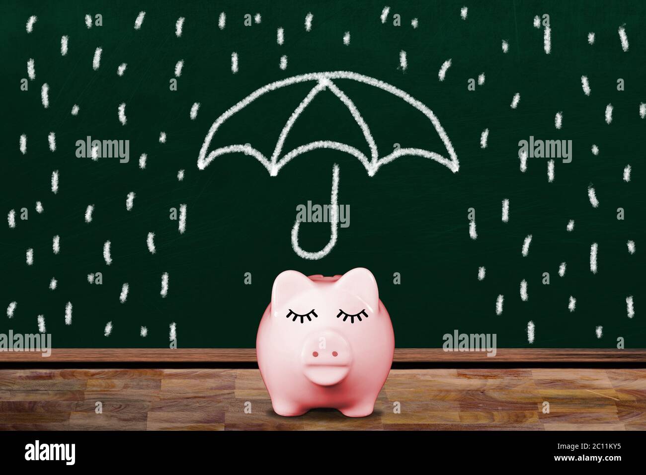 Saving for a rainy day with pink piggy bank in classroom with ...