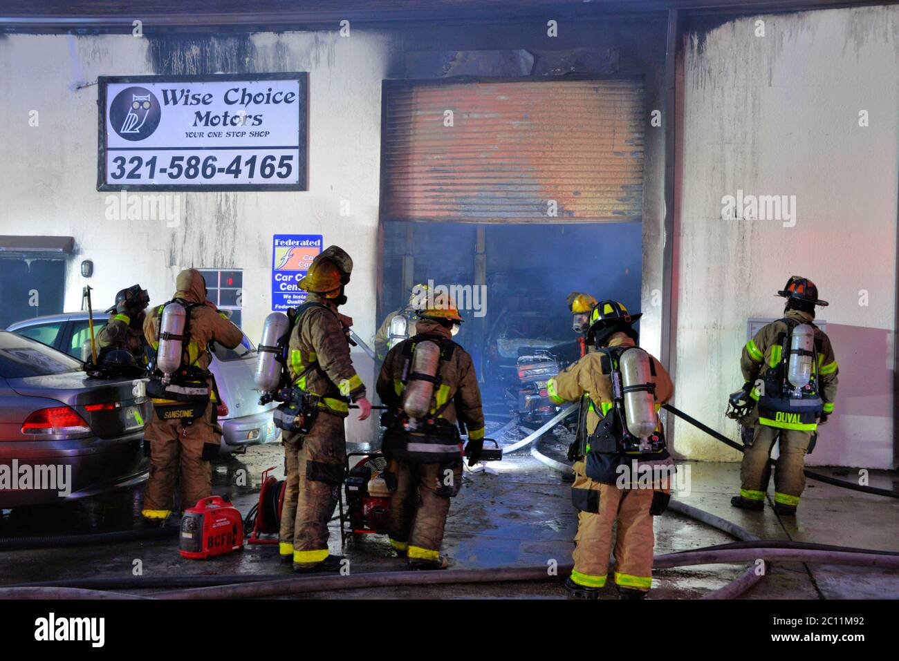 West Melbourne, Florida, USA. June 13, 2020. Early morning fire of suspicious origin sends one person to an Orlando burn unit. The fire in an automotive repair shop was contained by the Brevard County Fire Rescue crew to a single unit as the building had firewalls between units. Decontamination rules require the fireman to have their bunker gear washed with soap and water at the fire scene. Photo Credit: Julian Leek/Alamy Live News Stock Photo