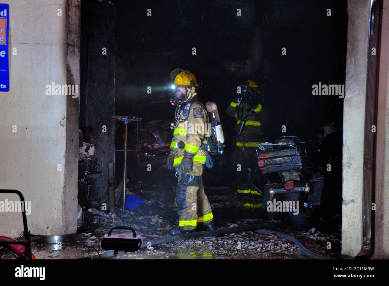 West Melbourne, Florida, USA. June 13, 2020. Early morning fire of suspicious origin sends one person to an Orlando burn unit. The fire in an automotive repair shop was contained by the Brevard County Fire Rescue crew to a single unit as the building had firewalls between units. Decontamination rules require the fireman to have their bunker gear washed with soap and water at the fire scene. Photo Credit: Julian Leek/Alamy Live News Stock Photo