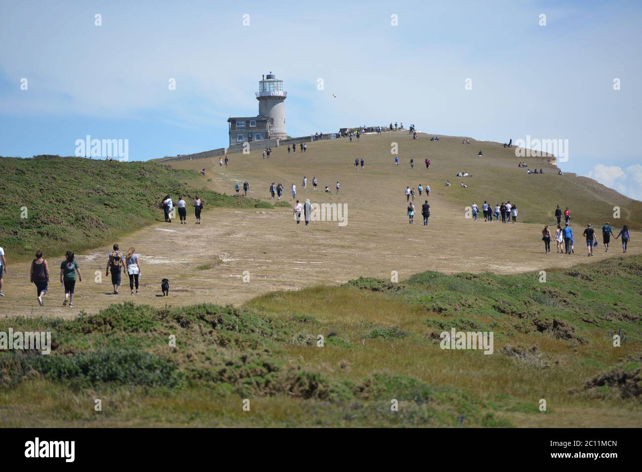 Birling Gap, East Sussex, UK. 13th June, 2020. Tourists get too close to the edge of the crumbling Seven Sisters white chalk cliffs on the Sussex Coast. The iconic cliffs tower up to 400ft above the English Channel. Credit: Peter Cripps/Alamy Live News Stock Photo
