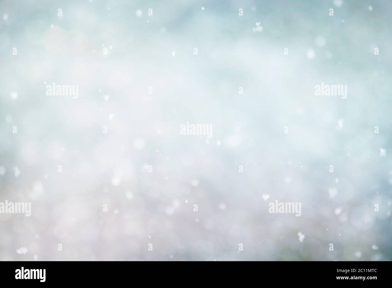 Snow falling and floating on the air, wintry xmas abstract background Stock Photo